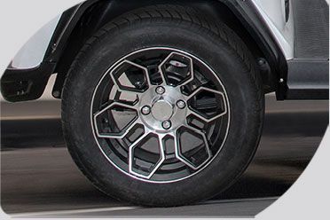 A close up of a wheel on a golf cart.