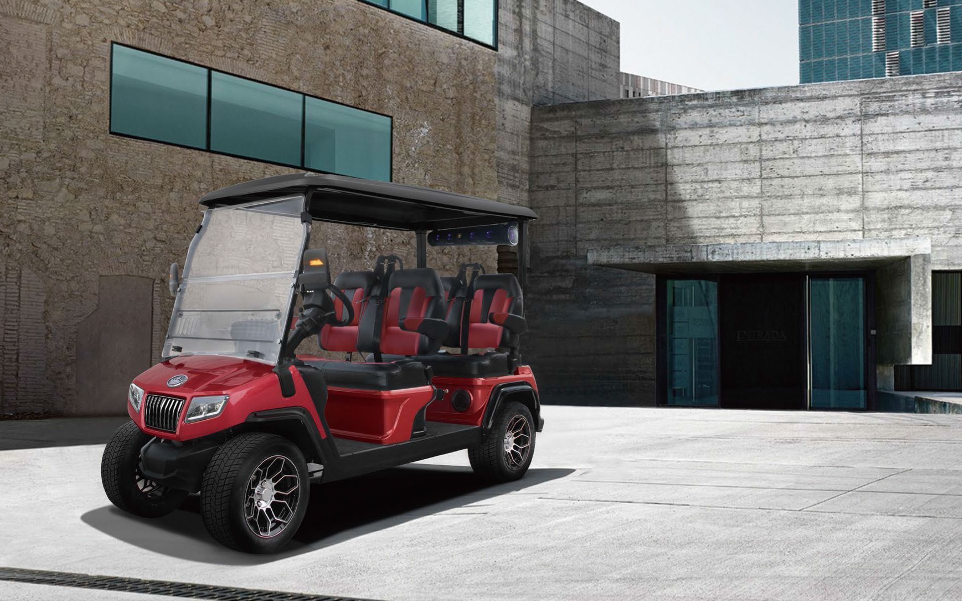 a red golf cart is parked in front of a building .