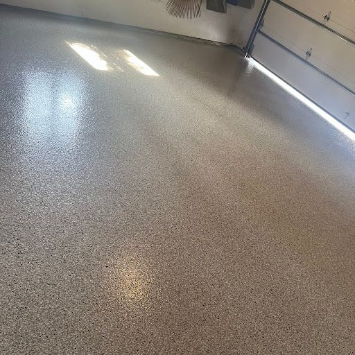 A garage with a shiny floor and a garage door.