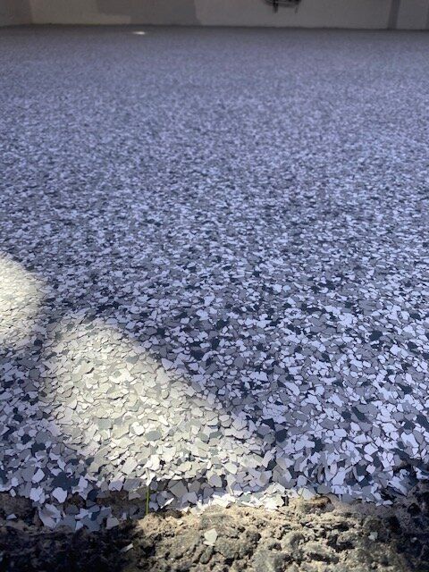 A close up of a carpet with a lot of small stones on it.