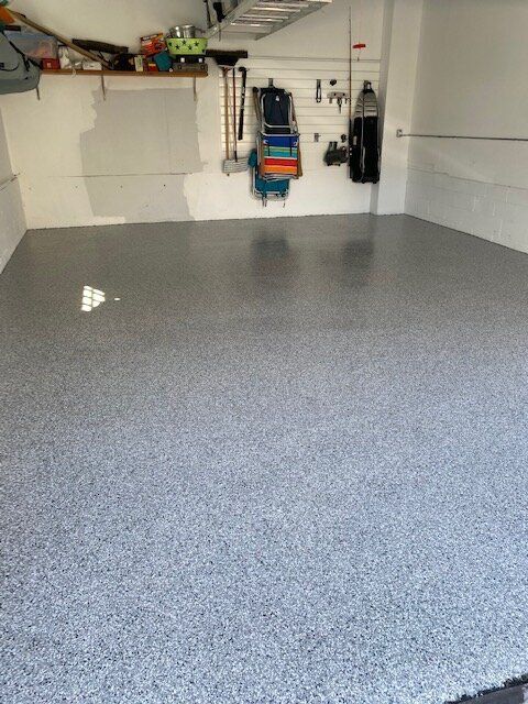 A garage with a gray floor and white walls.