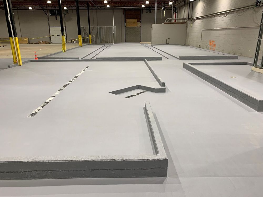 A large brewery with a concrete floor and a lot of stairs.