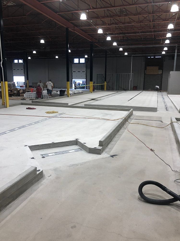 A vacuum cleaner is sitting on the floor of a large brewery.