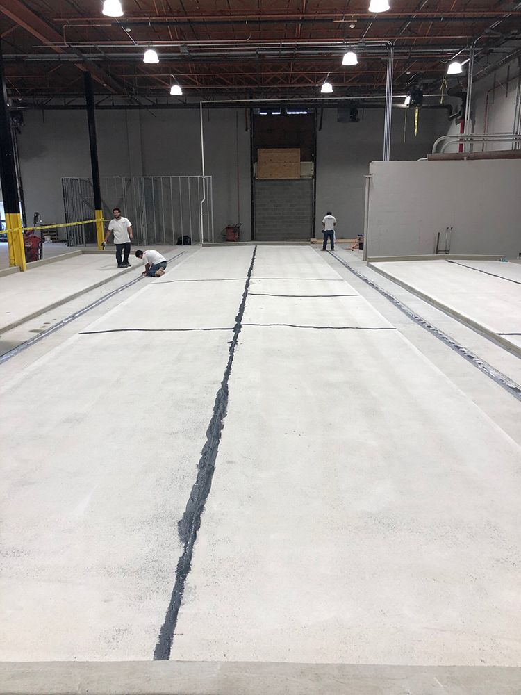 A vacuum cleaner is sitting on the floor of a large brewery.