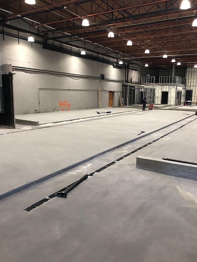 A large empty brewery with a lot of lights on the ceiling.