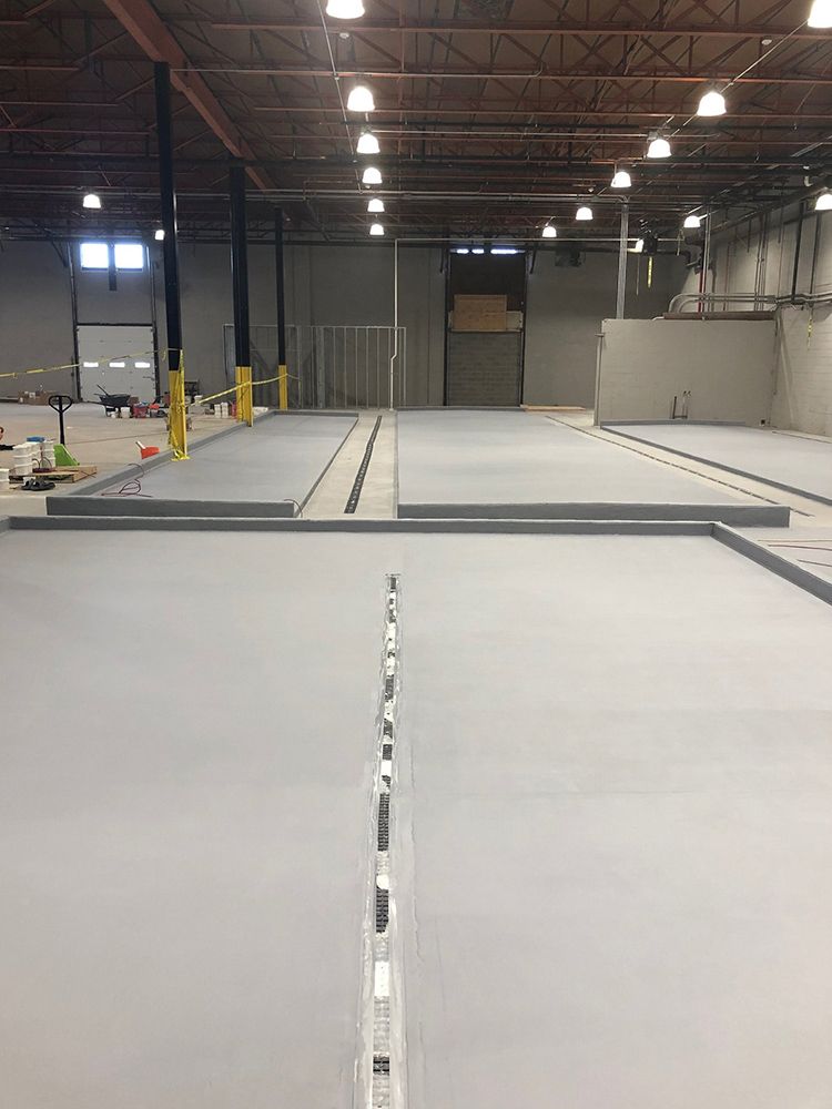 A large brewery with a concrete floor in the middle of it.