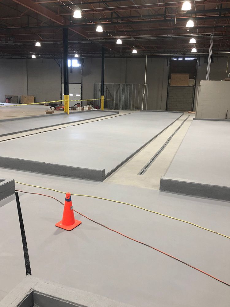 A large empty brewery with a cone on the floor.