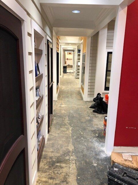 A hallway with a lot of doors and shelves