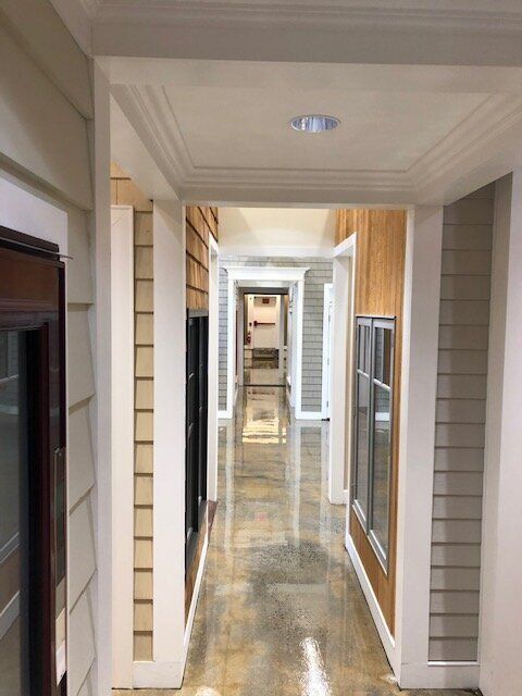 A long hallway with a lot of windows and doors