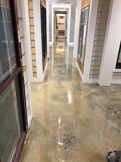 A hallway in a building with a concrete floor