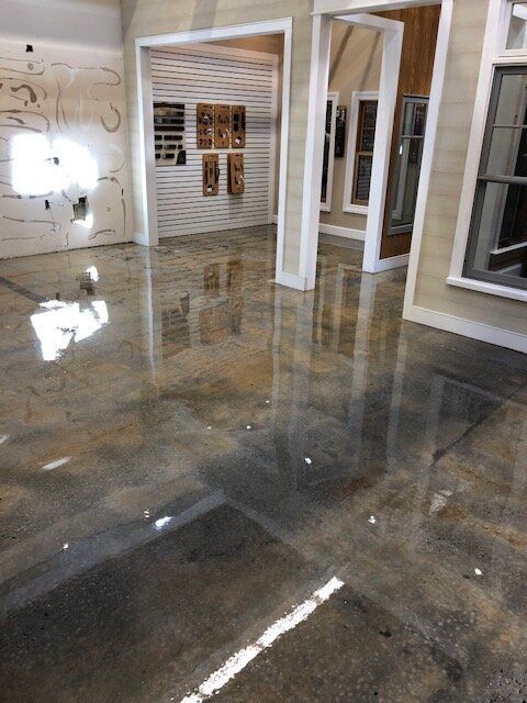 A room with a shiny floor and a reflection of windows