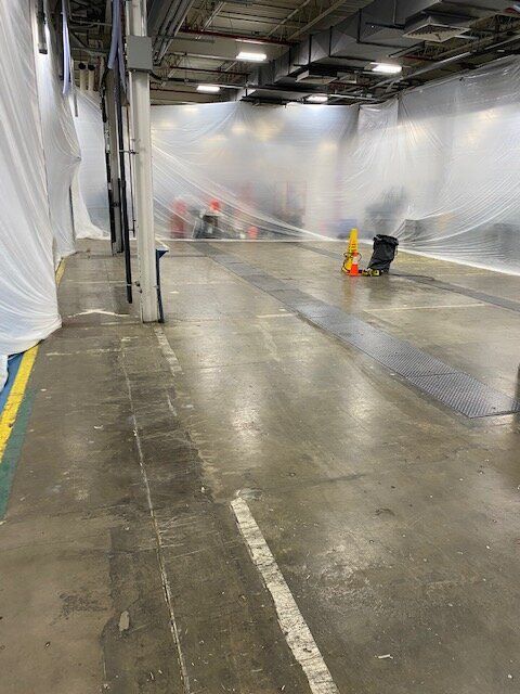 A manufacturing facility with a lot of plastic covering the walls and floor.