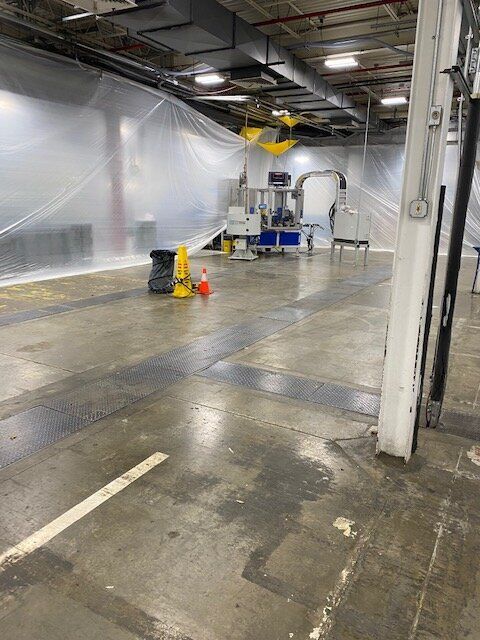 A manufacturing facility with a lot of plastic covering the walls and floors.