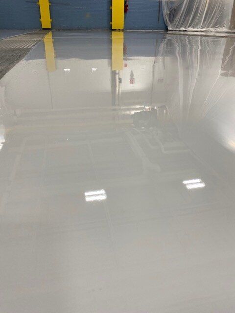 A close up of a white concrete floor in a building.