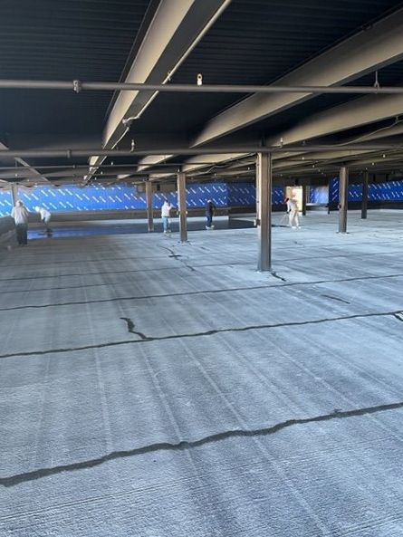 A large empty parking garage with a lot of columns