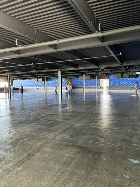 A large empty parking garage with people walking around