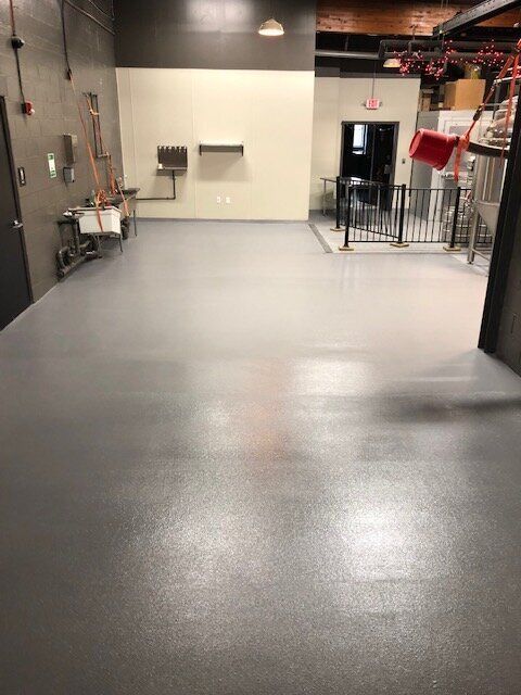 A large room with a gray floor and white walls