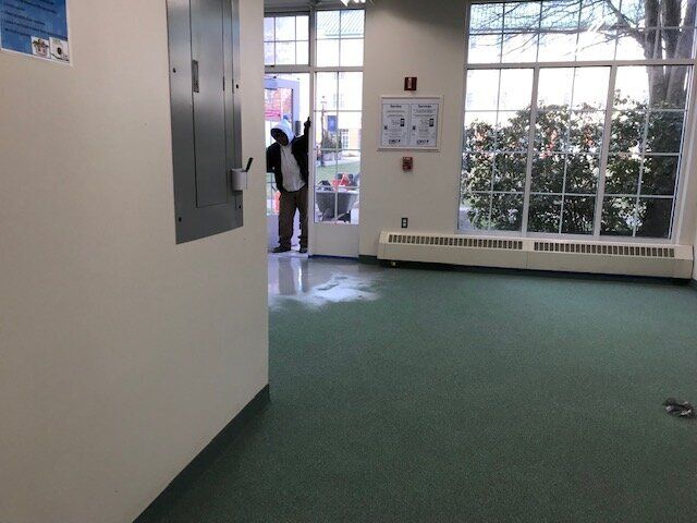 An empty room with a sign on the wall that says ' a '