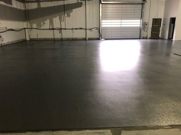 A garage with a concrete floor and a garage door.