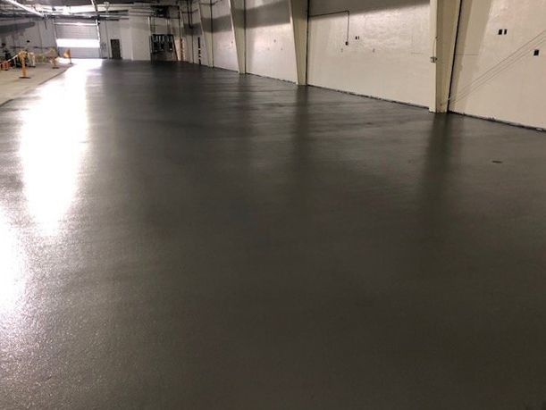 A room with a green floor and a yellow caution tape