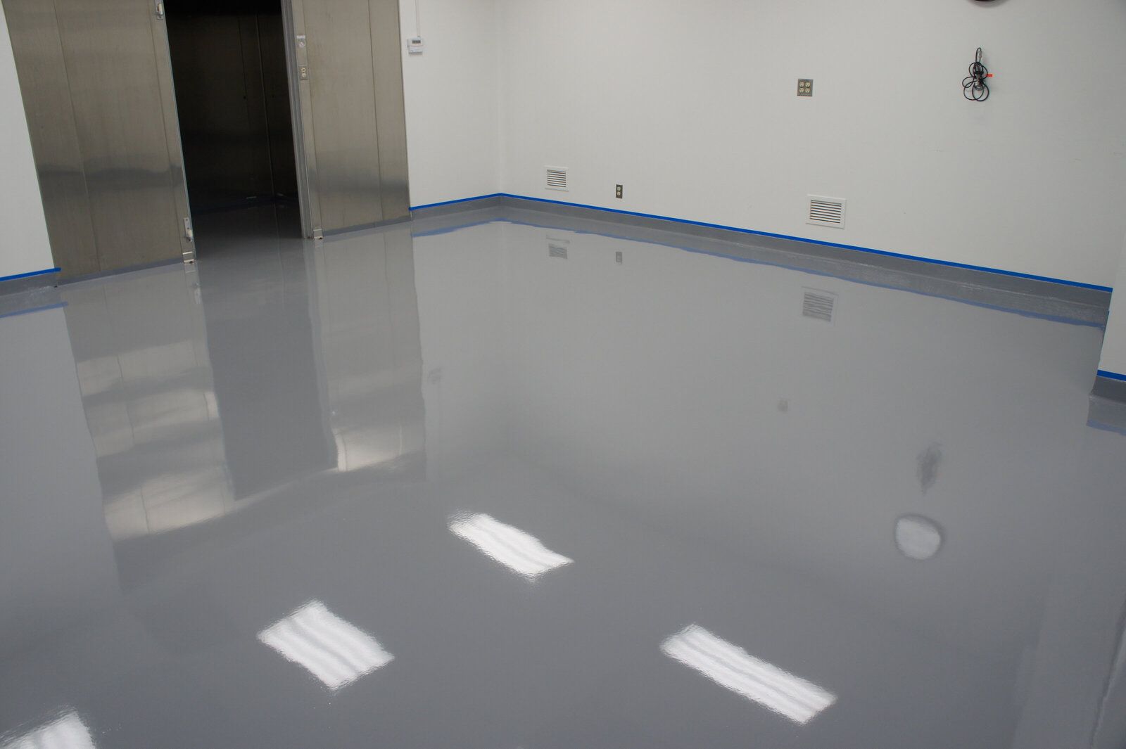 A room with a gray floor and white walls.