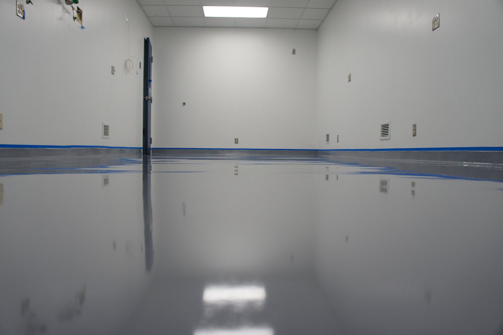 A room with a shiny floor and white walls