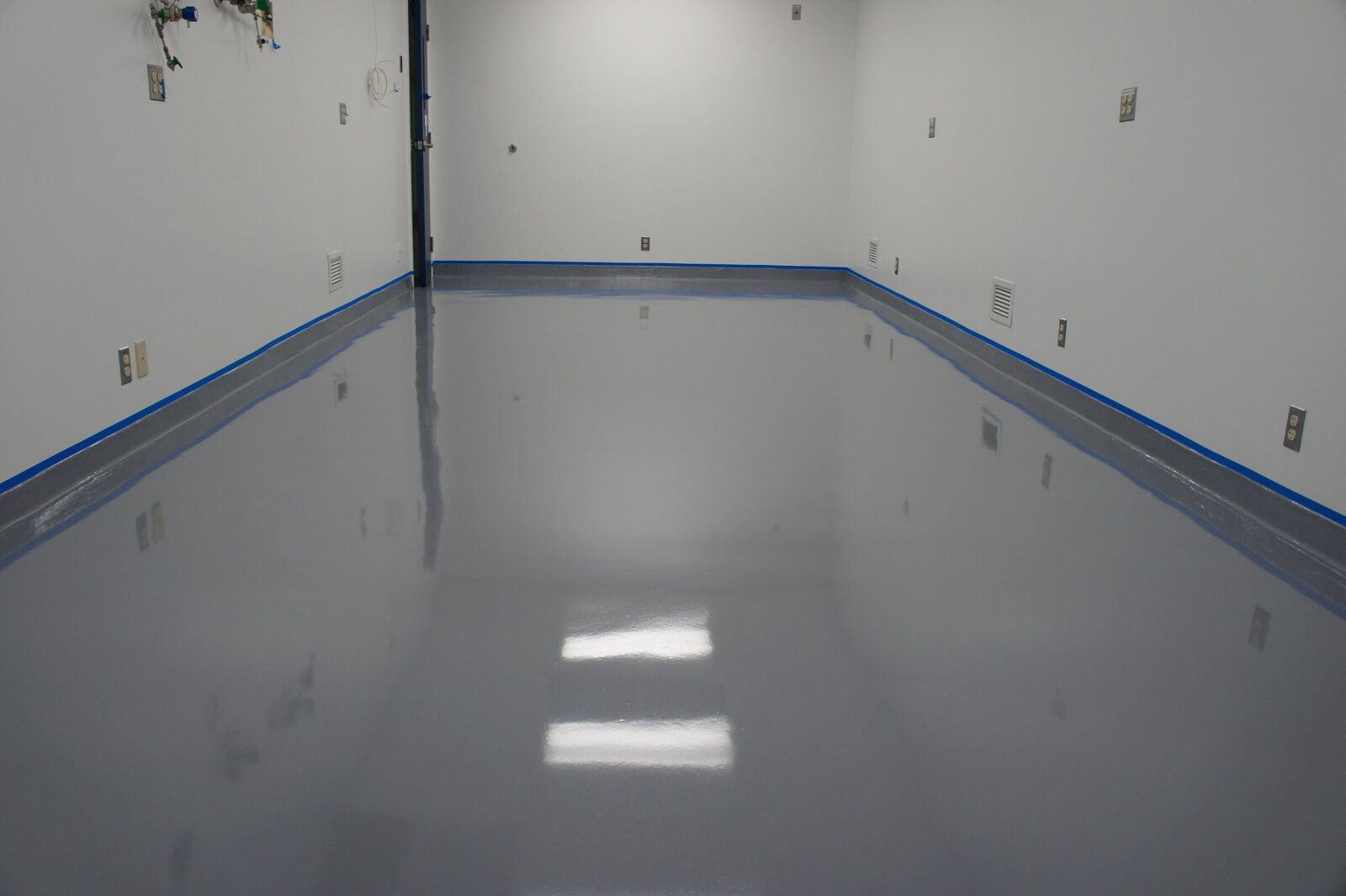 A large room with a gray floor and white walls.