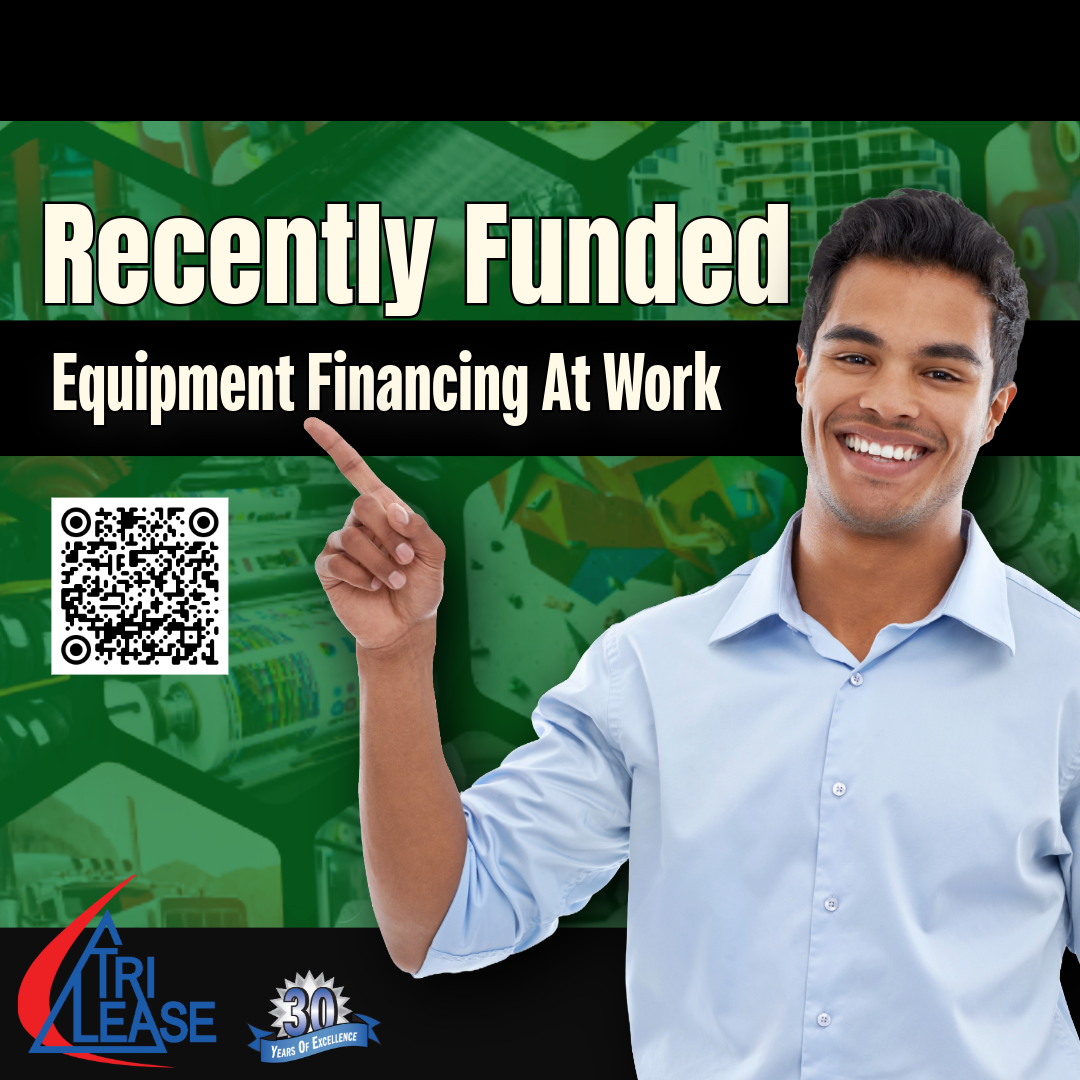 Man pointing to recently funded equipment from a variety of businesses and industries.