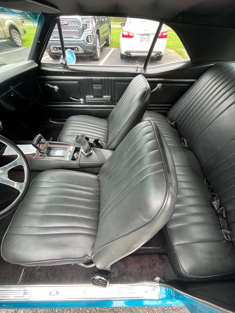 The inside of a car with black leather seats and a steering wheel.