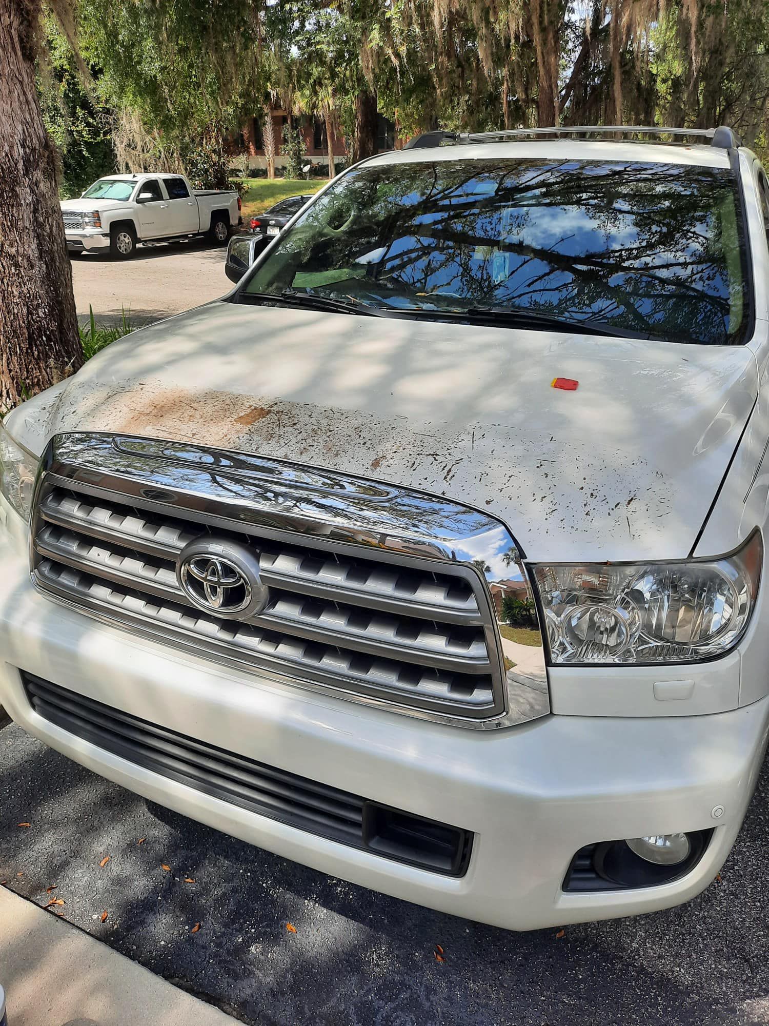 A white toyota tundra is parked on the side of the road.