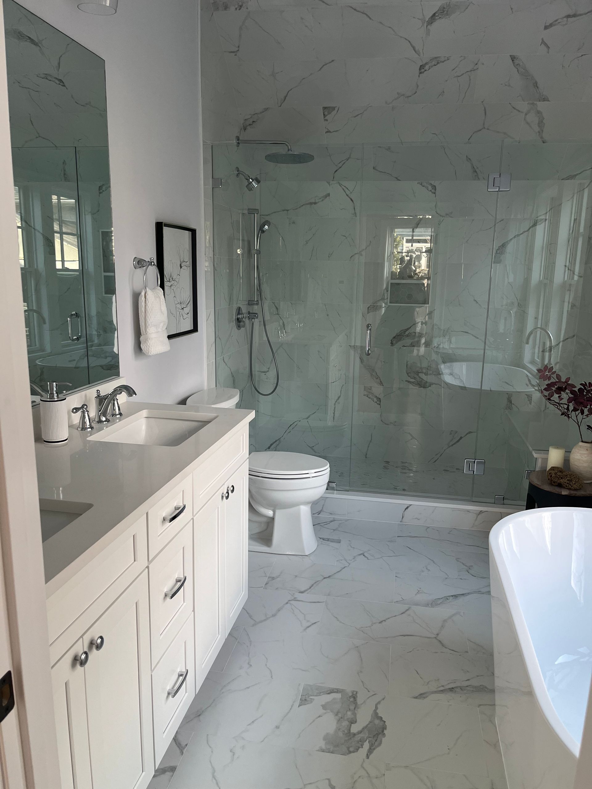 A bathroom with a sink, toilet, shower and bathtub.