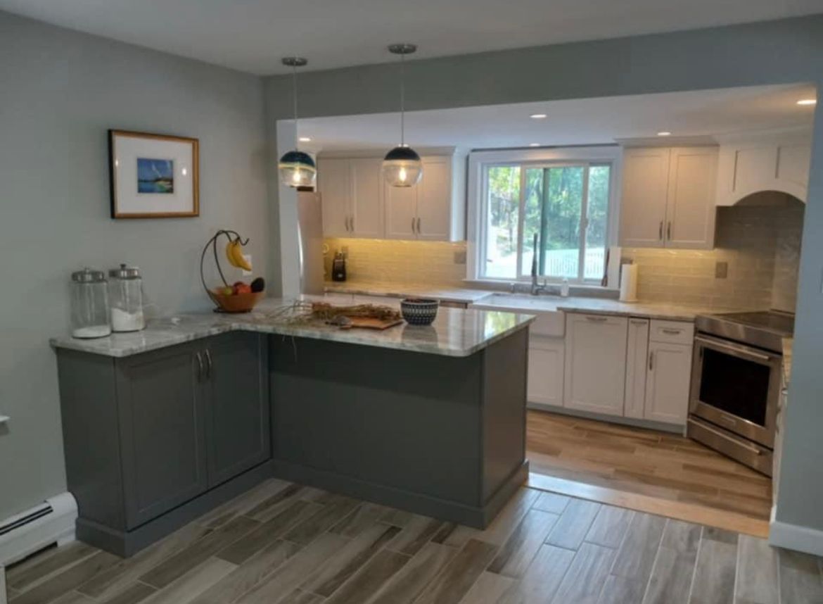 A kitchen with a large island and white cabinets