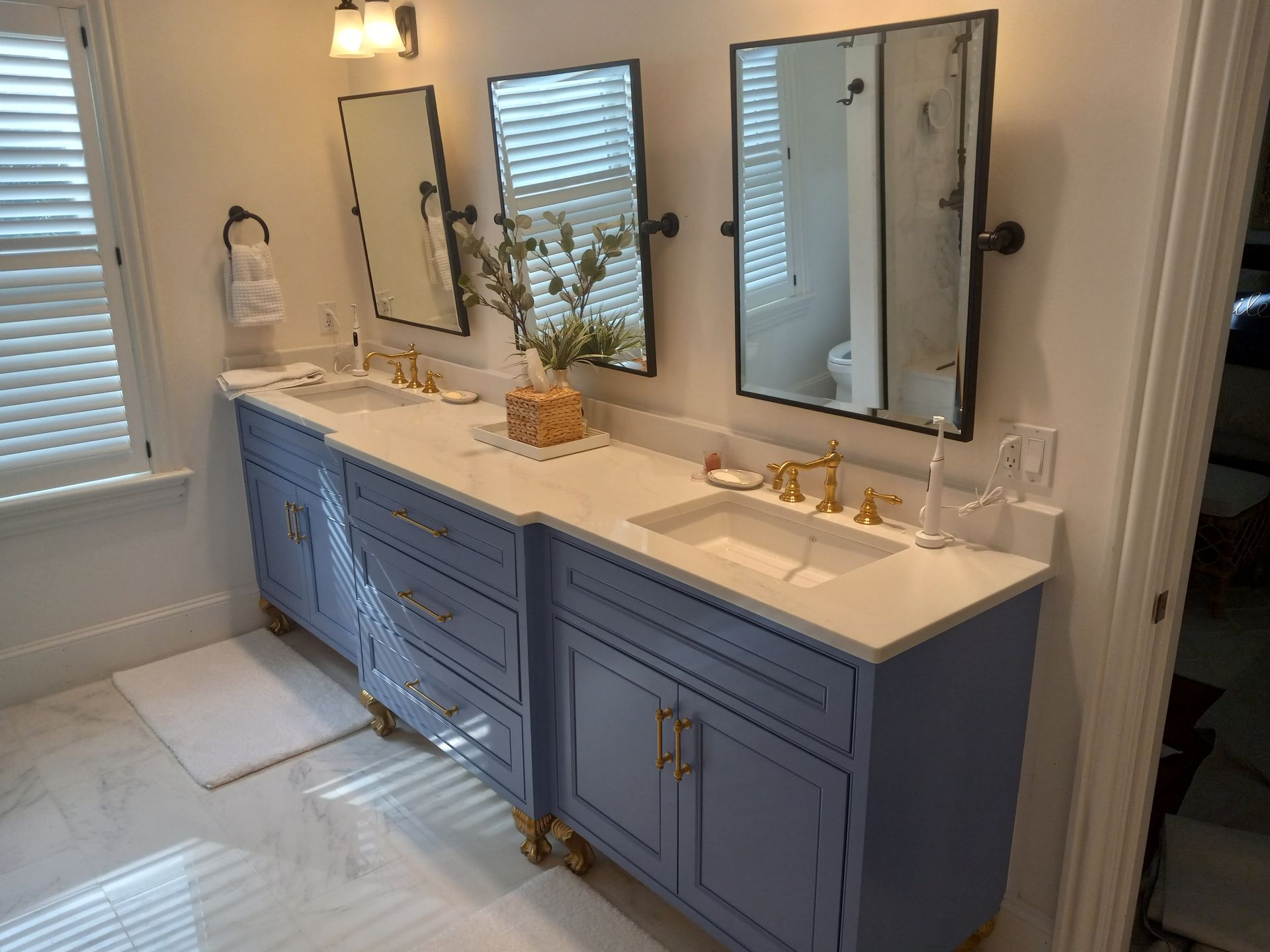 A bathroom with two sinks and two mirrors.