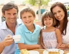 Smiling family outdoors, symbolizing the security provided by life insurance policies