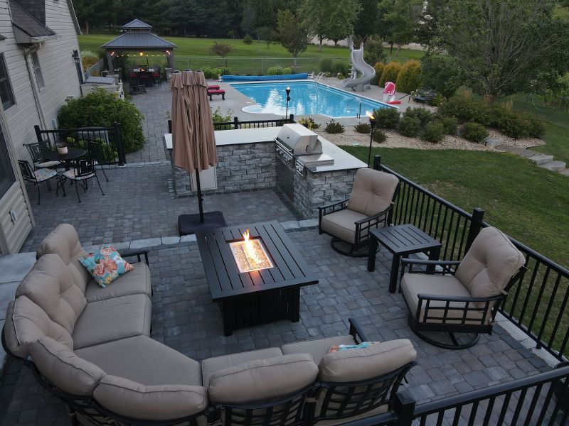 An aerial view of a patio with a fire pit