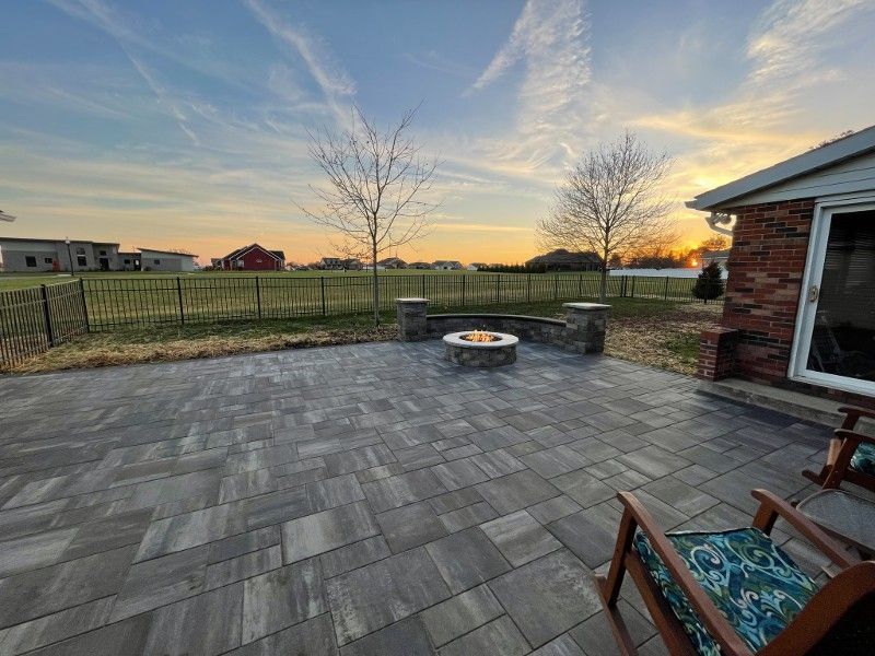 There is a fire pit in the middle of the patio.