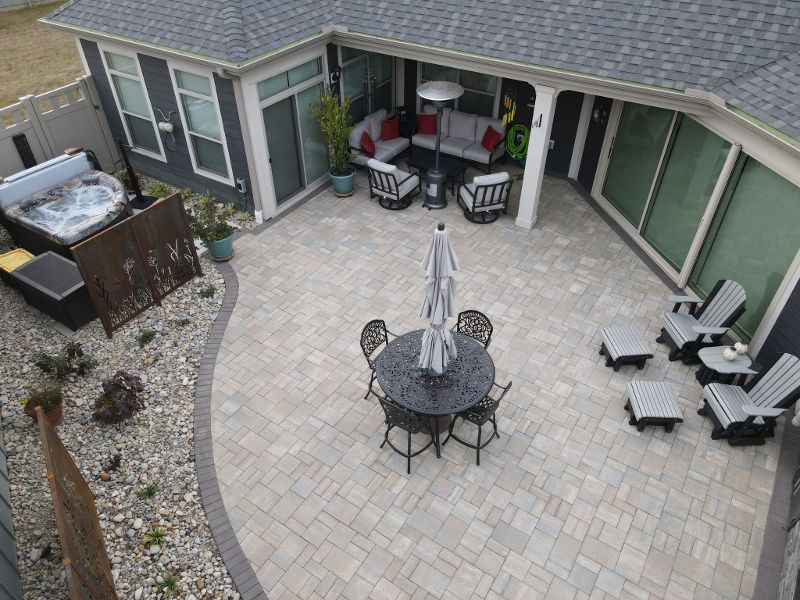 An aerial view of a patio with a table and chairs and a hot tub.