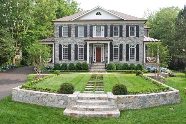 A large house with a lush green lawn in front of it