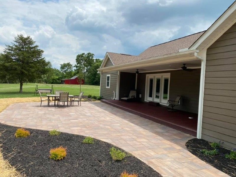 A house with a patio and a table and chairs in front of it