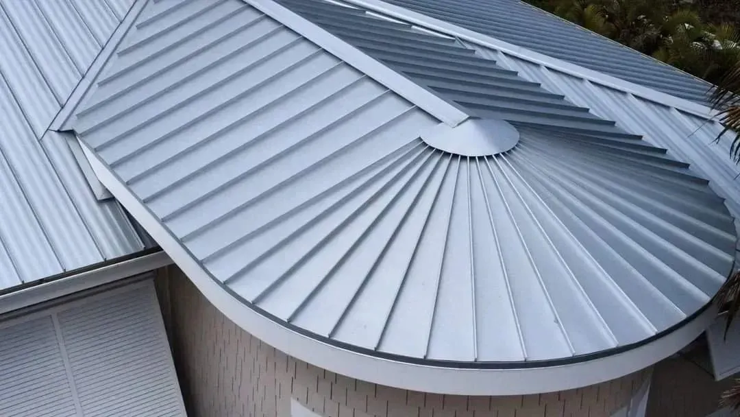 Silver metal roof with curved, fan-shaped design.