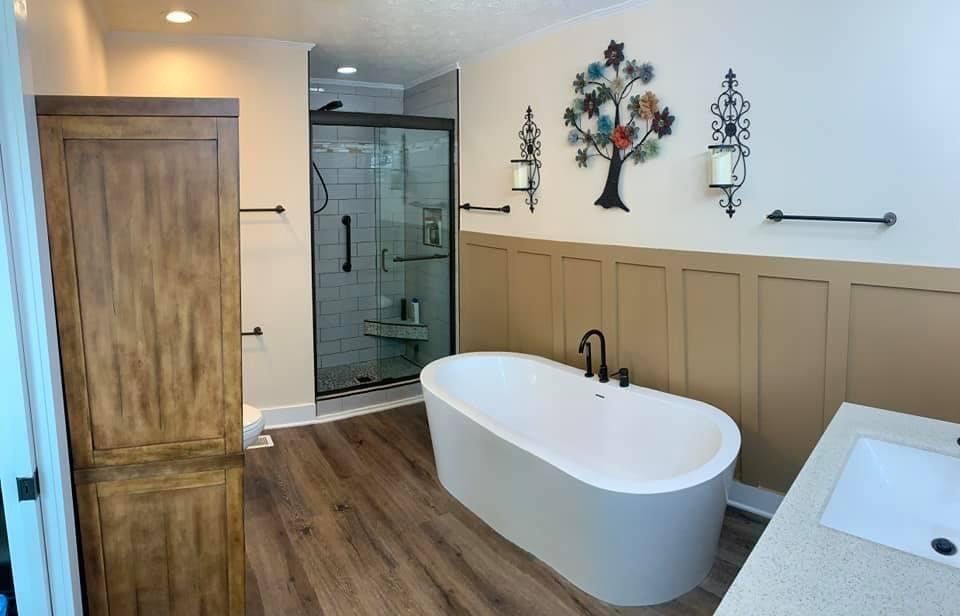 Bathroom with a bathtub, sink, and shower