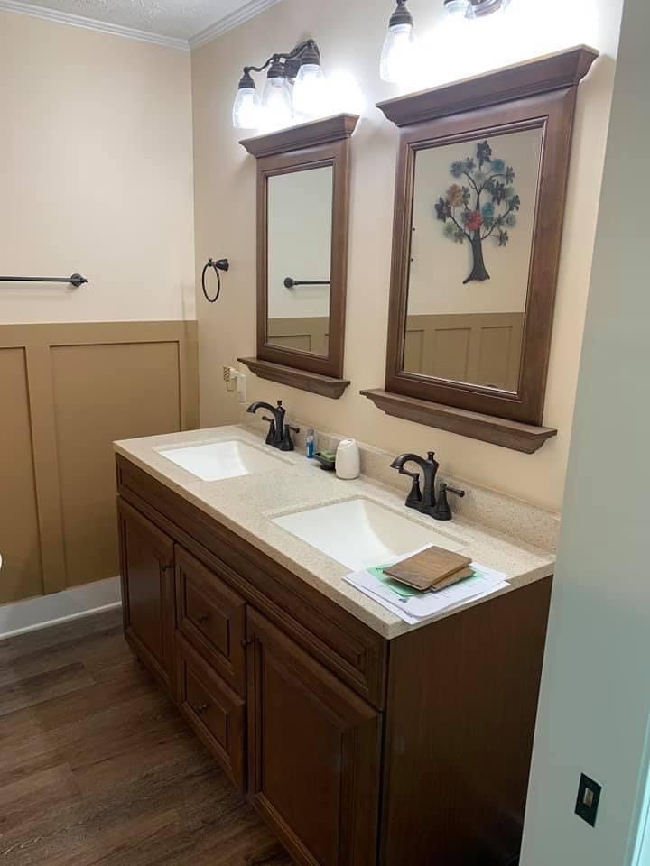 A bathroom with two sinks and two mirrors