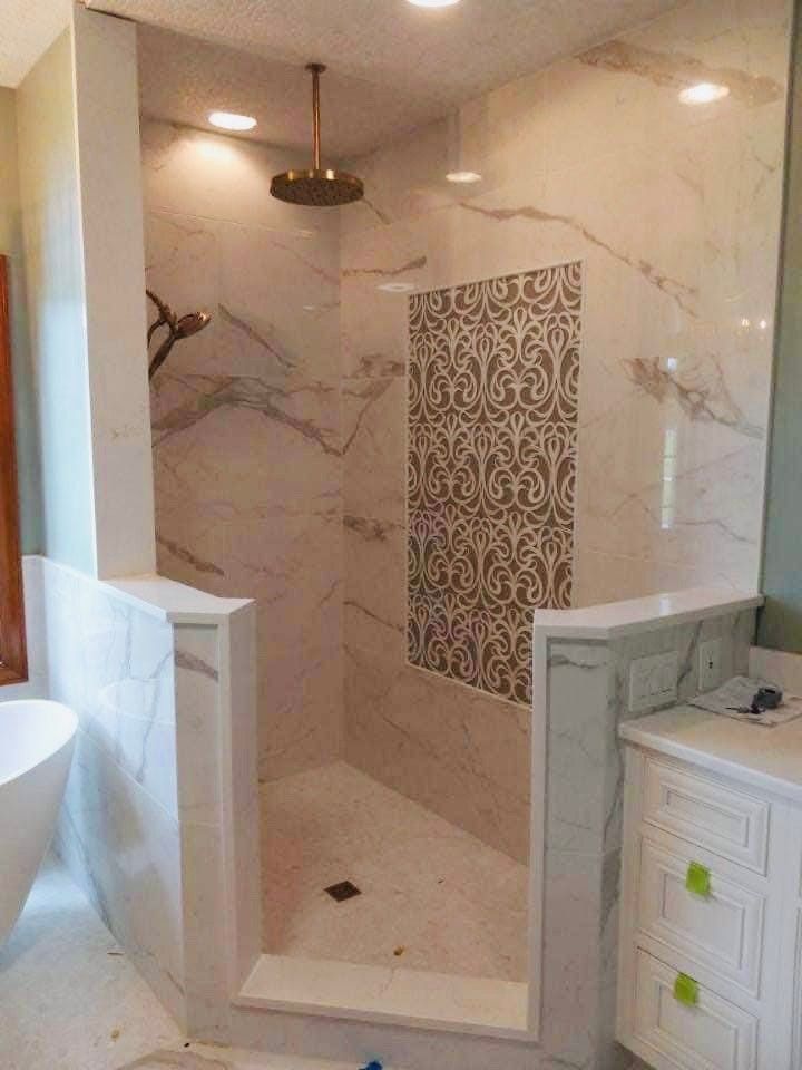 A bathroom with a walk in shower and a bathtub