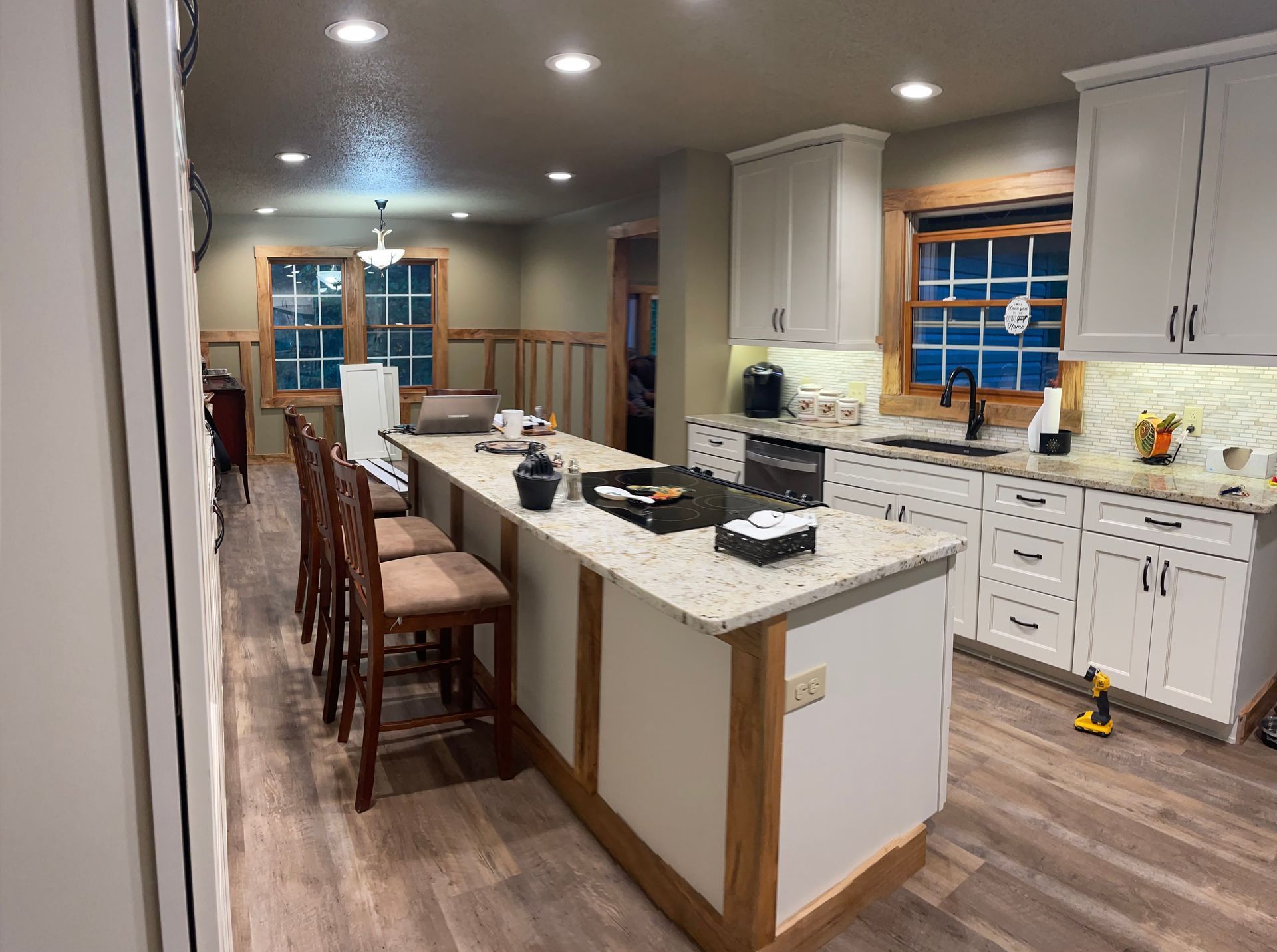 A kitchen with white cabinets