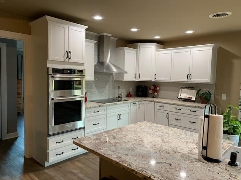 A kitchen with white cabinets