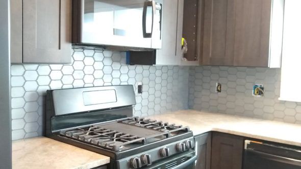 Kitchen with a stove, microwave, and dishwasher