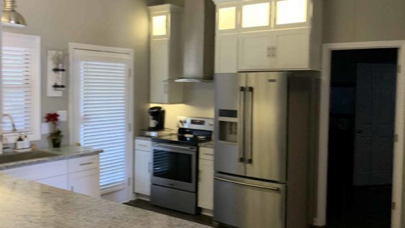 Kitchen with stainless steel appliances and white cabinets