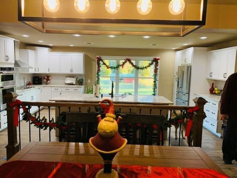 A kitchen with a table and chairs decorated for Christmas
