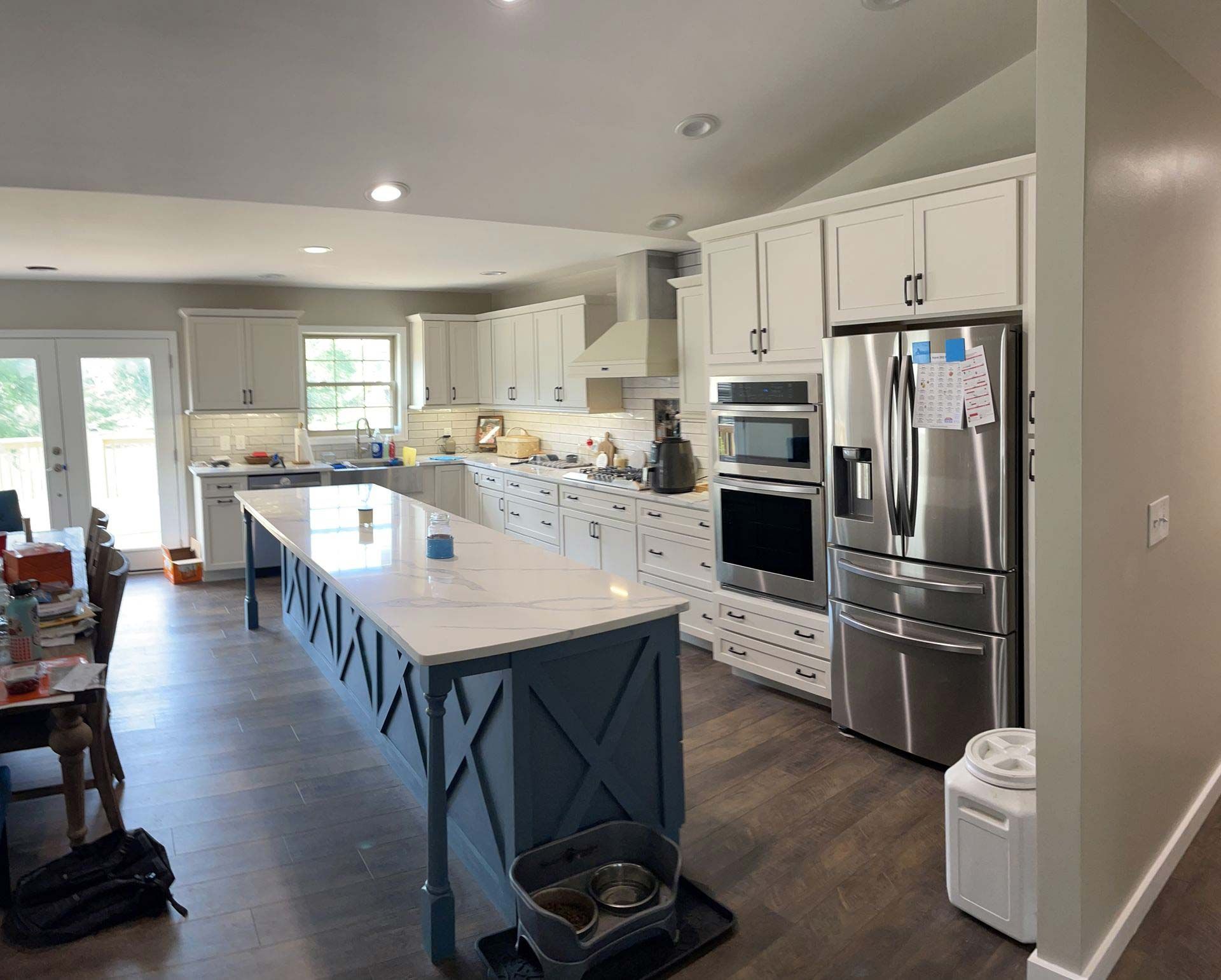 A kitchen with a large island and stainless steel appliances
