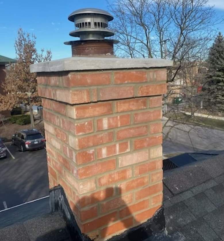 A brick chimney sitting on top of a roof